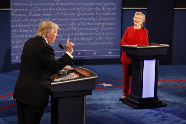 Republican U.S. presidential nominee Donald Trump speaks as Democratic U.S. presidential nominee Hillary Clinton listens during their first presidential debate at Hofstra University in Hempstead, New York, U.S., September 26, 2016. REUTERS/Rick Wilking