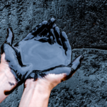 hands covered with crude oil