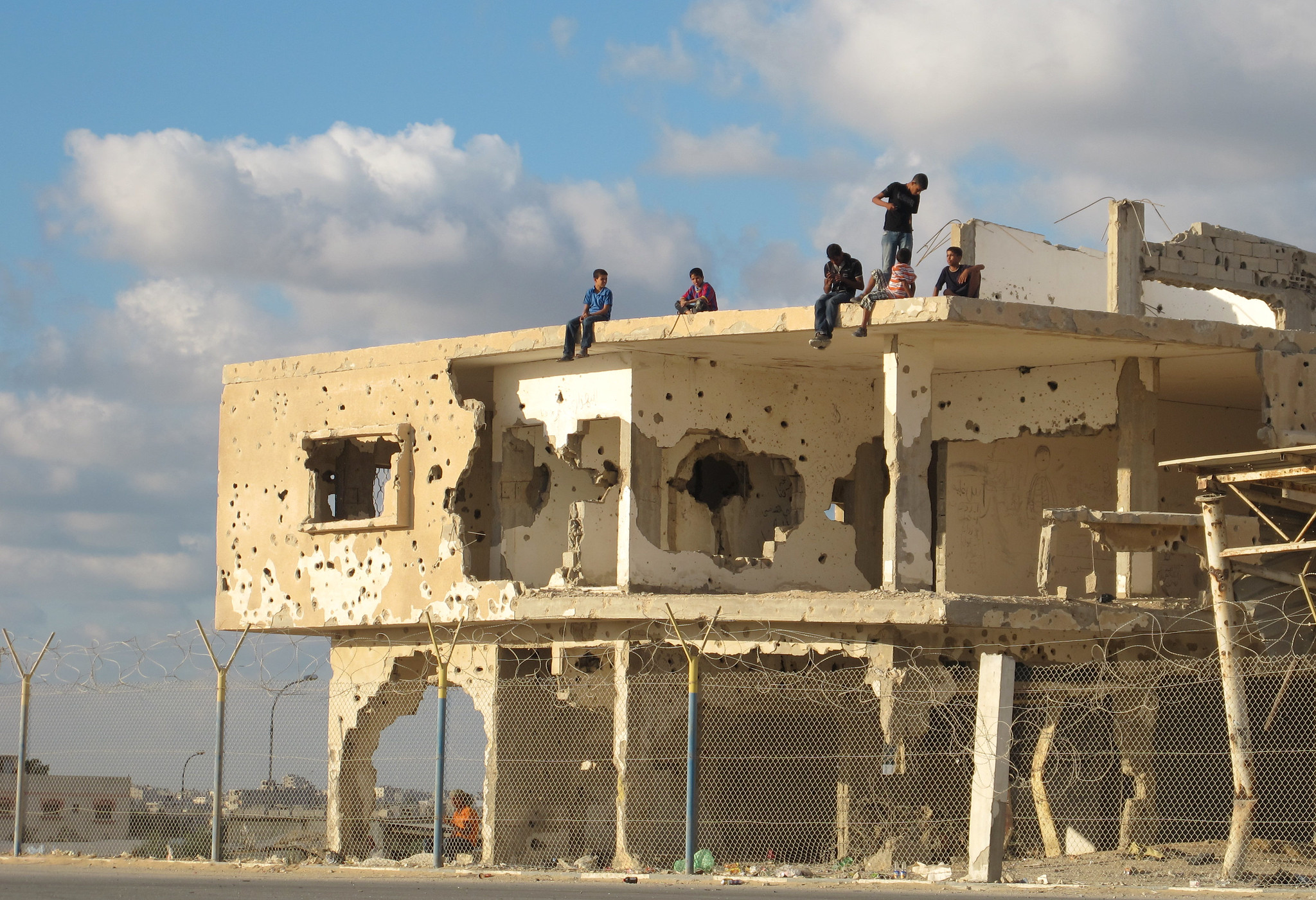 Children play atop a bullet-riddled building in Gaza