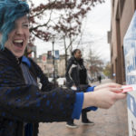 Voter placing ballot in drop box in King County, Washington