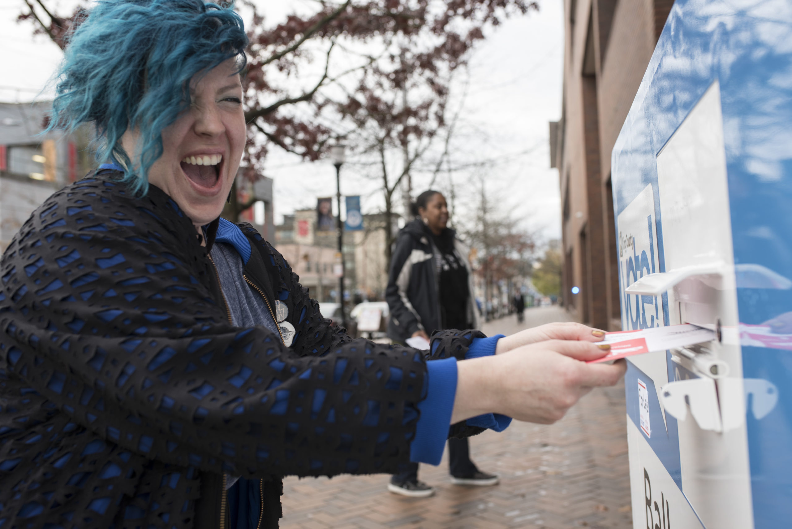 Voter placing ballot in drop box in King County, Washington