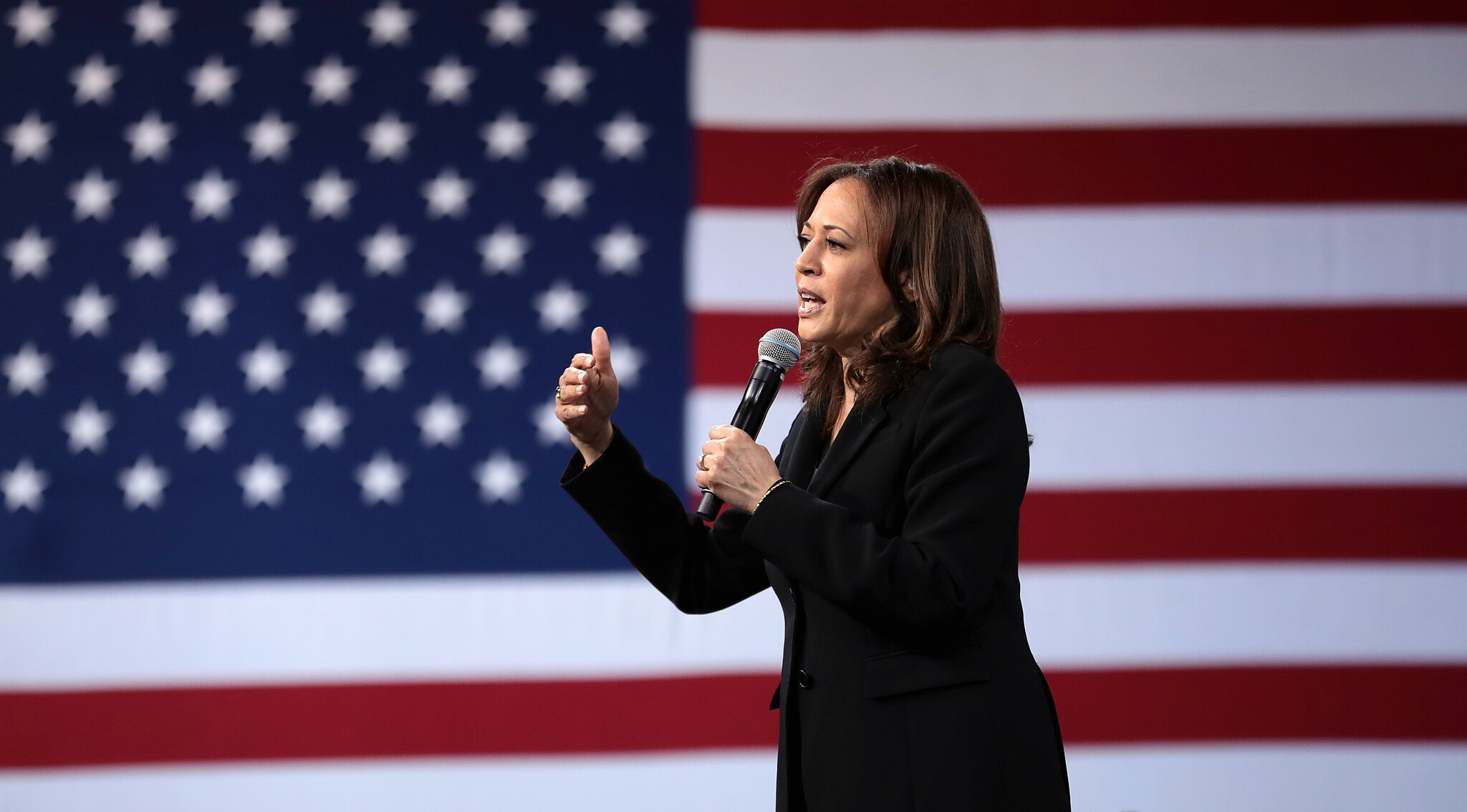 Kamala Harris with flag backdrop