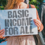 woman holding sign, basic income for all