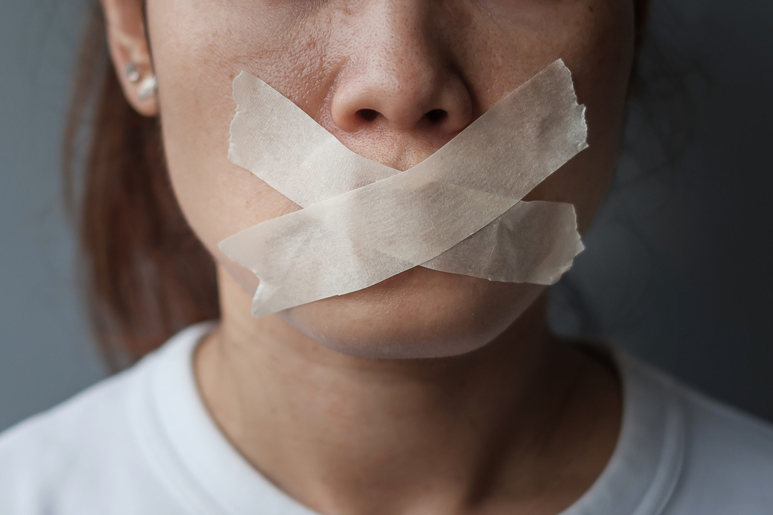 woman with mouth sealed in adhesive tape